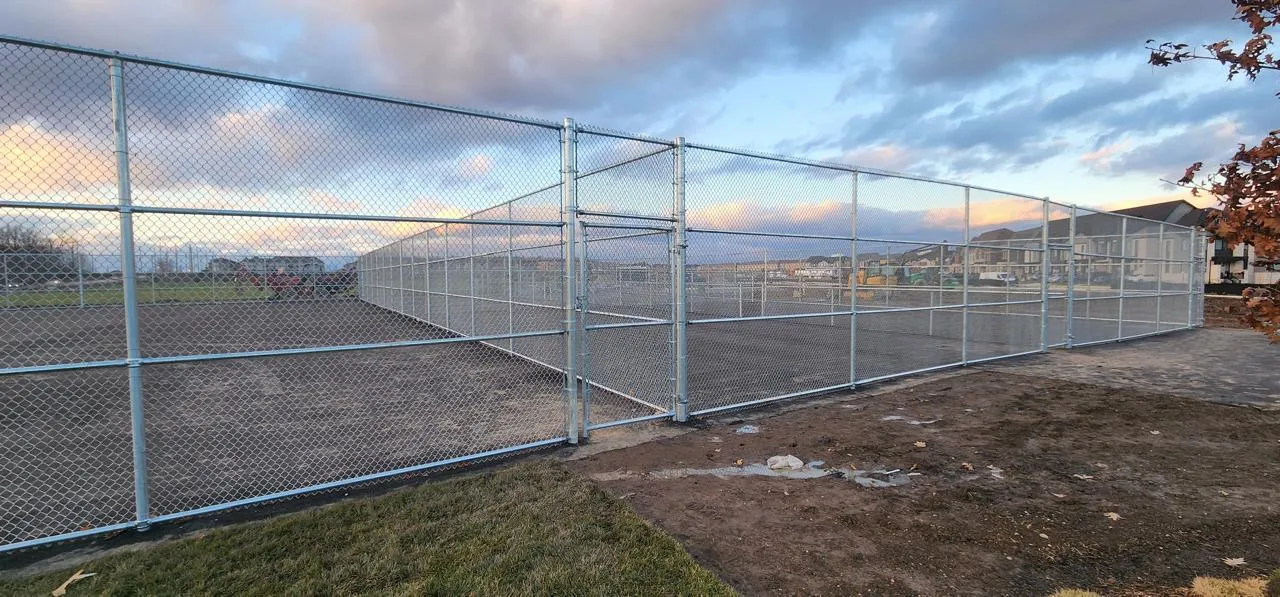Galvanized chain link fencing enclosing a sports court