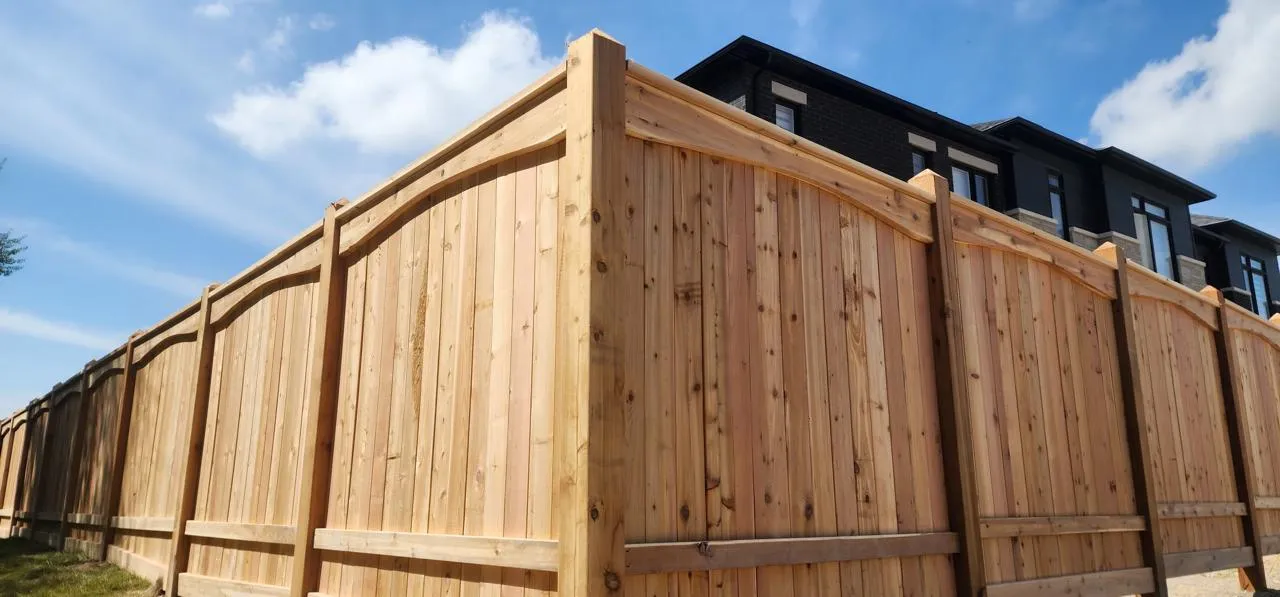 Cedar privacy fence corner detail against a blue sky
